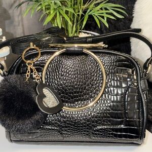 CARLOS SANTANAS Black Shoulder Bag with Gold Accents heart keychain and Pom Pom